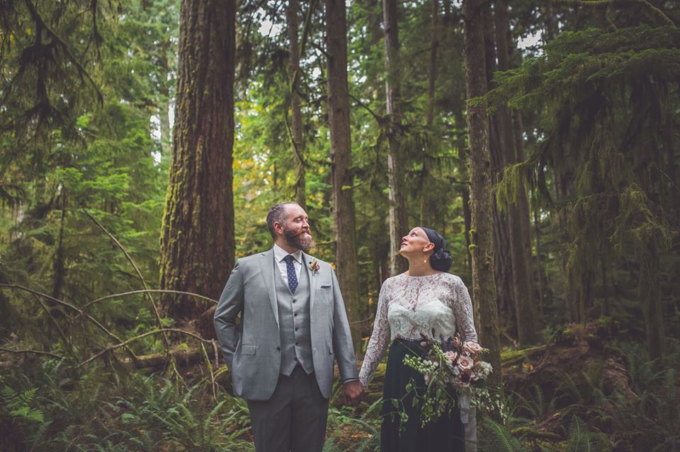 in Cathrdral Grover, a bruide appreciated the tall trees and a groom appreciates the bride