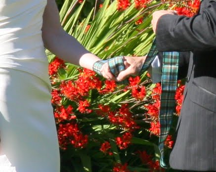 handfasting wrap with Tartan in garden at Hatley Castle